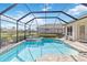 Sparkling screened pool with spa and lush landscaping at 4921 Woodhurst Dr, Sarasota, FL 34243