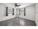 Bedroom with laminate floors, two windows, and neutral paint at 4925 Silk Oak Dr, Sarasota, FL 34232