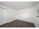 Bedroom featuring laminate floors, closet and neutral paint at 4925 Silk Oak Dr, Sarasota, FL 34232