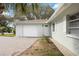 A well-maintained house with a white garage door and a brick driveway leading up to the front door at 4925 Silk Oak Dr, Sarasota, FL 34232