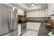 Well-lit kitchen features stainless steel appliances and colorful tile backsplash at 4925 Silk Oak Dr, Sarasota, FL 34232