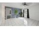 Spacious living room with tile floor and a wood accent wall at 4925 Silk Oak Dr, Sarasota, FL 34232