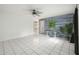 Living room boasts tile floors, a ceiling fan, and a decorative accent wall creating a stylish and spacious area at 4925 Silk Oak Dr, Sarasota, FL 34232