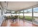 Enclosed patio featuring tile flooring and metal patio furniture, perfect for outdoor dining at 4925 Silk Oak Dr, Sarasota, FL 34232