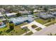 Aerial view of home on a well-maintained lot, with a manicured garden and large driveway at 512 Whitfield Ave, Sarasota, FL 34243