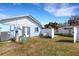 Backyard featuring a white fence, shed, and covered deck at 512 Whitfield Ave, Sarasota, FL 34243