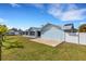 Backyard view showcasing the patio, privacy fence, and well-manicured lawn at 512 Whitfield Ave, Sarasota, FL 34243