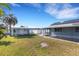 Backyard featuring a screened-in patio, white fence, grassy lawn, and shed at 512 Whitfield Ave, Sarasota, FL 34243