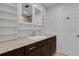 Bathroom with granite countertop, dark brown vanity, and mirrored medicine cabinet at 512 Whitfield Ave, Sarasota, FL 34243