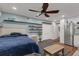 Main bedroom with hardwood floors, built-in shelving and ceiling fan at 512 Whitfield Ave, Sarasota, FL 34243