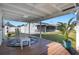 Covered deck featuring outdoor seating and potted plants, perfect for relaxation at 512 Whitfield Ave, Sarasota, FL 34243