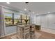 Bright dining area with table and four chairs, near the home's entry at 512 Whitfield Ave, Sarasota, FL 34243