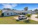 Lovely single-story home features lush green lawn, mature trees, and circular driveway at 512 Whitfield Ave, Sarasota, FL 34243