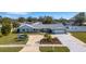 Attractive light blue single-story home with a large driveway and landscaping at 512 Whitfield Ave, Sarasota, FL 34243