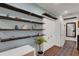 Bright hallway with hardwood floors and built-in shelving at 512 Whitfield Ave, Sarasota, FL 34243