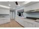 White kitchen with breakfast bar and view to living room at 512 Whitfield Ave, Sarasota, FL 34243