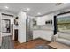 Modern kitchenette with white cabinets and granite countertops at 512 Whitfield Ave, Sarasota, FL 34243