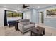 Relaxing living room featuring a gray sectional sofa and a ceiling fan at 512 Whitfield Ave, Sarasota, FL 34243