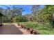 Wooden deck overlooking a verdant backyard filled with mature trees and foliage at 5180 Meldon Cir, Sarasota, FL 34232