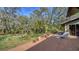 Inviting wooden deck with a lounge chair overlooking a lush backyard with mature landscaping at 5180 Meldon Cir, Sarasota, FL 34232