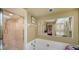 Neutral bathroom features a shower and bathtub with a large mirror at 5180 Meldon Cir, Sarasota, FL 34232