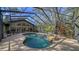 Backyard featuring a screened-in pool and view of the home at 5180 Meldon Cir, Sarasota, FL 34232