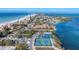 Aerial view of community with tennis courts, beach, and waterfront at 527 Sutton Pl # T-12, Longboat Key, FL 34228