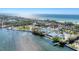 Aerial view showing waterfront community, tennis courts, and ocean at 527 Sutton Pl # T-12, Longboat Key, FL 34228