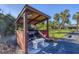 Community BBQ area with covered pavilion and seating at 527 Sutton Pl # T-12, Longboat Key, FL 34228