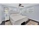 Spacious bedroom with a white platform bed and ceiling fan at 527 Sutton Pl # T-12, Longboat Key, FL 34228