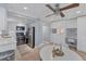 Modern dining area with built-in workspace and ceiling fan at 527 Sutton Pl # T-12, Longboat Key, FL 34228