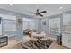 Modern dining area with white table and chairs and ceiling fan at 527 Sutton Pl # T-12, Longboat Key, FL 34228