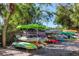 Several kayaks are neatly stored on a rack under the shade at 527 Sutton Pl # T-12, Longboat Key, FL 34228