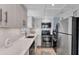 Modern kitchen with stainless steel appliances and white cabinetry at 527 Sutton Pl # T-12, Longboat Key, FL 34228