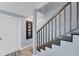 Modern staircase with dark wood steps and metal railing at 527 Sutton Pl # T-12, Longboat Key, FL 34228