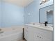 Clean bathroom with white vanity, quartz countertop, and a soaking tub at 5388 Pamela Wood Way # 8, Sarasota, FL 34233