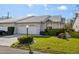 Front view of a lovely villa with a white garage door and lush landscaping at 5388 Pamela Wood Way # 8, Sarasota, FL 34233