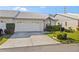 Exterior of charming villa with white vinyl siding, and a well-manicured lawn at 5388 Pamela Wood Way # 8, Sarasota, FL 34233