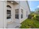 Inviting front entry with a white door and landscaping at 5388 Pamela Wood Way # 8, Sarasota, FL 34233