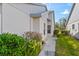 Landscaped side yard with walkway and lush greenery at 5388 Pamela Wood Way # 8, Sarasota, FL 34233