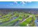 Expansive aerial view of a sprawling golf course community with lush greenery, water features, and residential homes at 5507 Country Lakes Trl, Sarasota, FL 34243