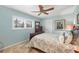 Bedroom with neutral walls, a ceiling fan, natural light from window and a decorative painting at 5507 Country Lakes Trl, Sarasota, FL 34243