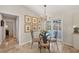 Bright dining area with a glass table, decorative chairs, and views of the pool area through French doors at 5507 Country Lakes Trl, Sarasota, FL 34243