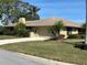 House exterior showcasing a garage and well-maintained lawn at 5507 Country Lakes Trl, Sarasota, FL 34243