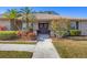 Charming home featuring a double-door entrance, manicured landscaping, and beautiful flowers at 5507 Country Lakes Trl, Sarasota, FL 34243