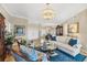 Elegant living room featuring a beautiful chandelier, stylish furniture, and bright natural light at 5507 Country Lakes Trl, Sarasota, FL 34243