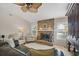 Cozy living room with a brick fireplace, ceiling fan, and neutral color palette at 5507 Country Lakes Trl, Sarasota, FL 34243