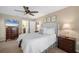 Comfortable main bedroom showcasing a plush bed, warm lighting, and neutral decor at 5507 Country Lakes Trl, Sarasota, FL 34243