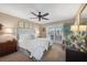 Relaxing main bedroom featuring a plush bed, natural light, and outdoor access at 5507 Country Lakes Trl, Sarasota, FL 34243