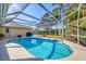 Inviting screened-in pool area with a sparkling pool and ample space for relaxation at 5507 Country Lakes Trl, Sarasota, FL 34243